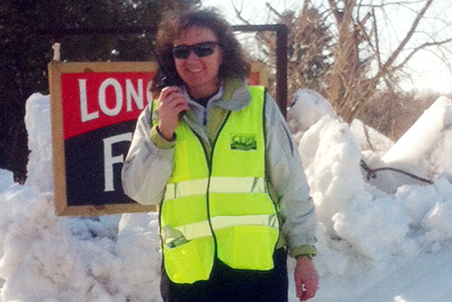 C-CERT member Sherri Condon, accounting specialist for auxiliary operations and campus services, speaks to fellow C-CERT members through a two-way radio transceiver  from MoConaughy Parking Lot, located at Long Lane Farm on Long Lane. All C-CERT members used the radios to communicate to each other and Transportation Services.