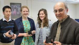 Psychology majors Julian Zhong '13, Ashley Swan '13 and Tacie Moskowitz ’13 work with Professor of Psychology John Seamon in the Memory Lab at Wesleyan. The team is studying if a memory camera can help patients with Alzheimer’s disease.