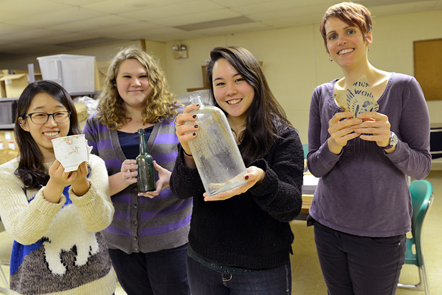 Hyunjin "Chelsey" Cho '13, Sarah Chrystler '13, Amy Cao '15 and Sarah Croucher, assistant professor of anthropology, assistant professor of archaeology, hold artifacts collected from the "Beman Triangle" site near Wesleyan. The pieces will be on exhibit April 4-May 31 in downtown Middletown. 