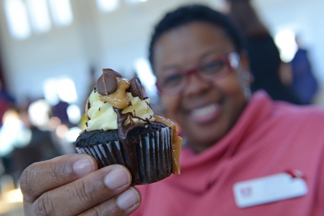 Andrea Kelly, program and events coordinator at at the Office of Admission, tries a peanut butter chocolate cupcake from Sweet Harmony Café and Bakery. 