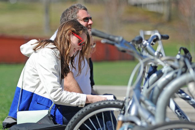 An admitted student reads through her WesFest literature at Usdan's Huss Courtyard. 