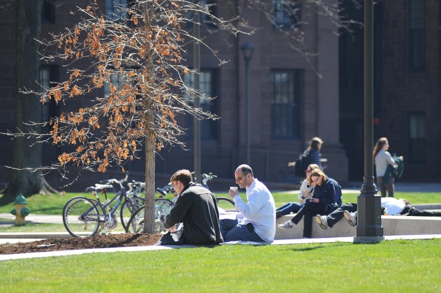 Families visiting for WesFest enjoy the spring weather outside Usdan University Center.