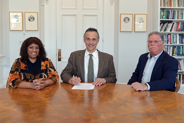 Wesleyan President Michael S. Roth signed an agreement between Wesleyan and Vermont Law School that guarantees admission for College of the Environment graduates meeting GPA and LSAT thresholds into Vermont's Environmental Law Program. At left, Sonia Mañjon, vice president for institutional partnerships and chief diversity officer, and at right, Barry Chernoff, director of College of the Environment, accompanied President Roth at the signing on April 3.