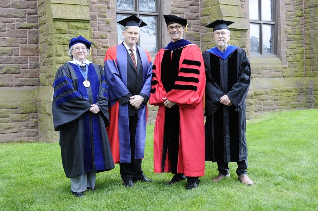 Wesleyan faculty Jeanine Basinger, Erik Grimmer-Solem and Phillip Wagoner received Binswanger Prizes for Excellence in Teaching on May 26. They are pictured here with Wesleyan President Michael Roth, third from left. 