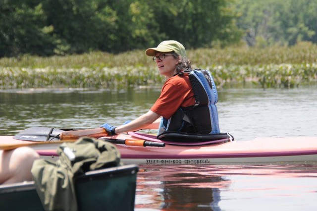 Elise Springer '90, associate professor of philosophy and Jonah Center Board Member, looks for wildlife on Mattabesset River. Springer's philosophical work includes reflection on ecological awareness and critical interventions. She has served as a fellow at Wesleyan's College of the Environment and studied the history and legacy of Middletown's industrial dam sites. 