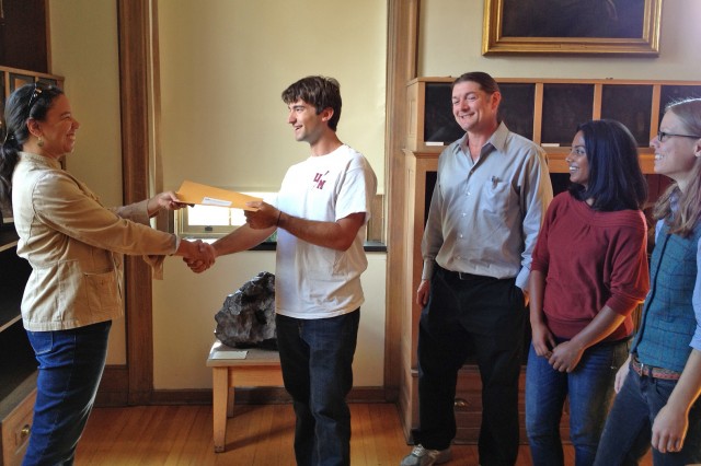 Peter Martin ’14 accepts a scholarship award from Martha Gilmore, chair and associate professor of earth and environmental sciences.