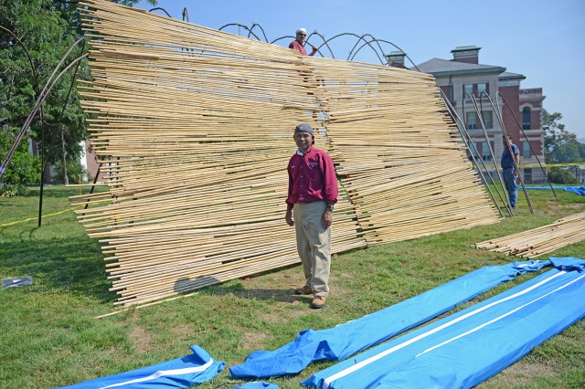 Prith Chuth, materials handler, unpacked dozens of bags of bamboo. 