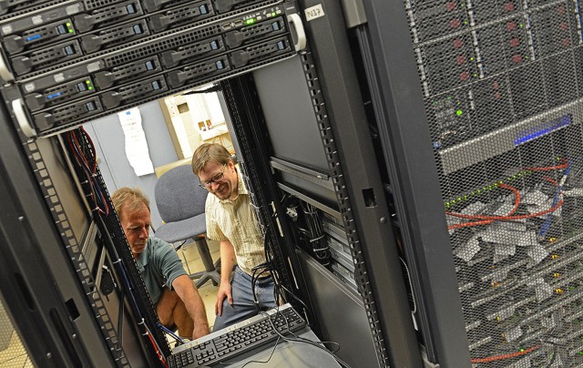 Henk Meij, unix systems group manager in Information Technology Services, and Francis Starr, professor of physics, look over Wesleyan's new high-performance computer platform, located on the fifth floor of ITS. The new cluster runs calculations up to 50 times faster than the previous cluster, installed in 2010. The new cluster also offers an additional 50 terabytes of disk space for a total of 100 terabytes.