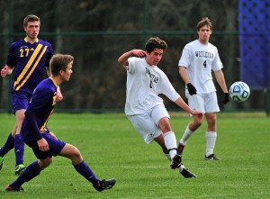 Brandon Sousa '16 (#8) sends the ball up field while Ben Bratt '15 (#4) looks on during a NESCAC semifinal game vs. Williams.  Sousa and Bratt were both first-team all-NESCAC while Bratt also was academic all-NESCAC and all-sportsmanship."  (photo by Peter Stein '84).