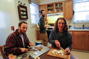 From left, Jon Lubeck, prepares a meal with co-op co-organizers Scott Zimmer '14 and Will Curran-Groome '14. 