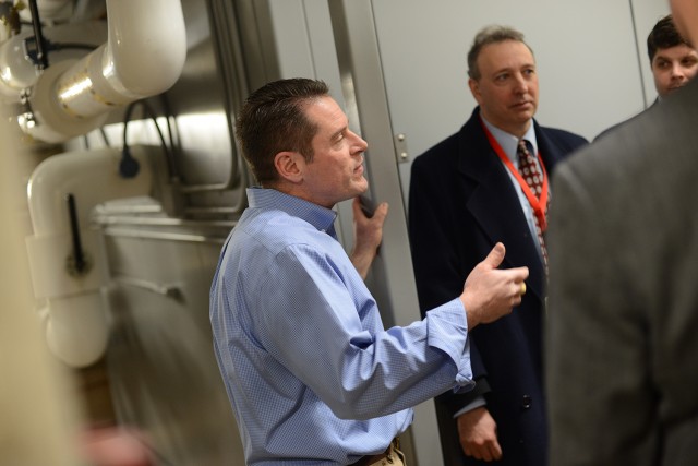 Alan Rubacha, director of Physical Plant, led a tour of Wesleyan's new natural gas Combined Heat and Power engines. The generator package will deliver 4,700 mWh annually.