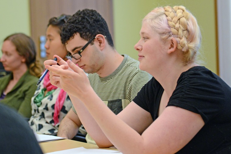 Conference participants discuss topics of poetry.