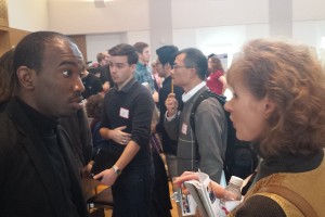 Psychology Graduate Student Jalen Alexander '14 speaks with an alumna about his QAC research. 