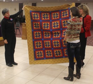 Kyle Foley receives the Quilt of Valor from Jane Dougherty, the Connecticut Quilt of Valor representative, and Deborah Sierpinski, administrative assistant at Wesleyan.