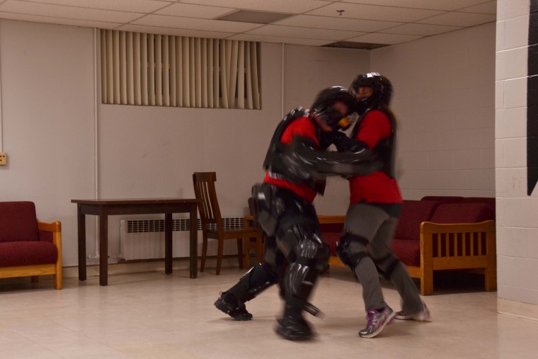 Lt. Jay Mantie, in the RAD protective suit, attacks Officer Kathy Burdick.