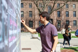 A student writes on the cube.