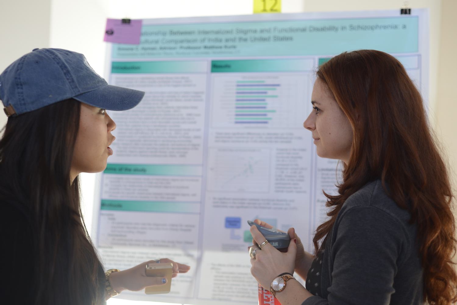 Simone Hyman '15, right, discusses her research on "The Relationship Between Internalized Stigma and Functional Disability in Schizophrenia: A Cross-Cultural Comparison of India and the United States" with another psychology major, Sarah Seo '16.