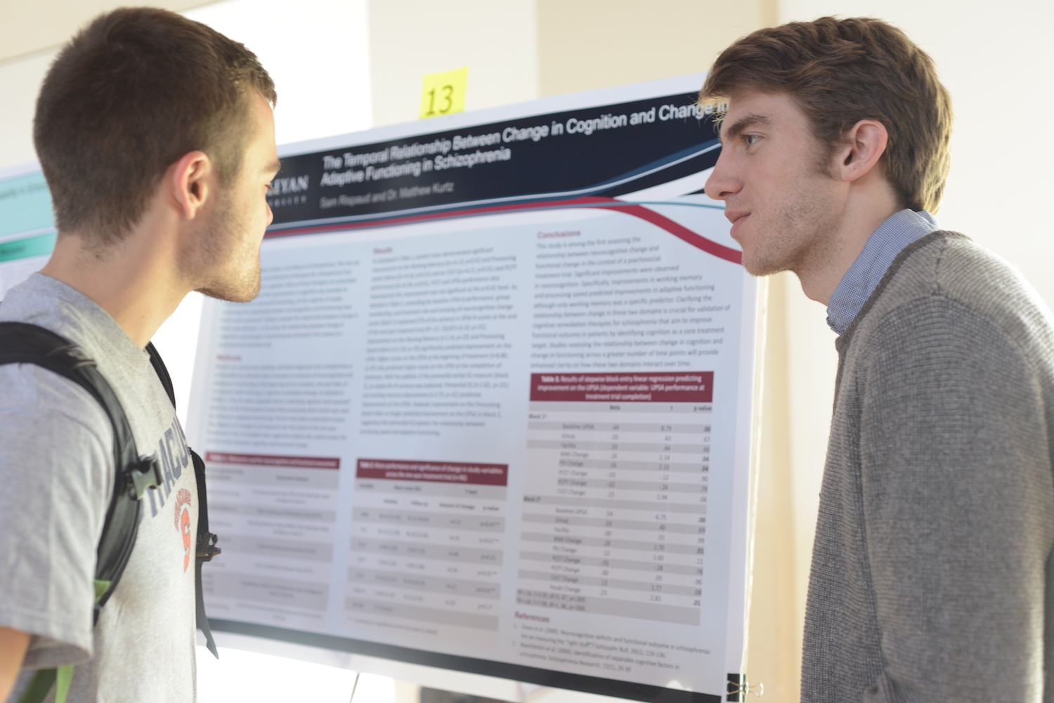 Sam Rispaud '15, right, discusses his research, "The temporal relationship between change in cognition and change in adaptive functioning in schizophrenia," with Patrick Masi-Phelps '15.