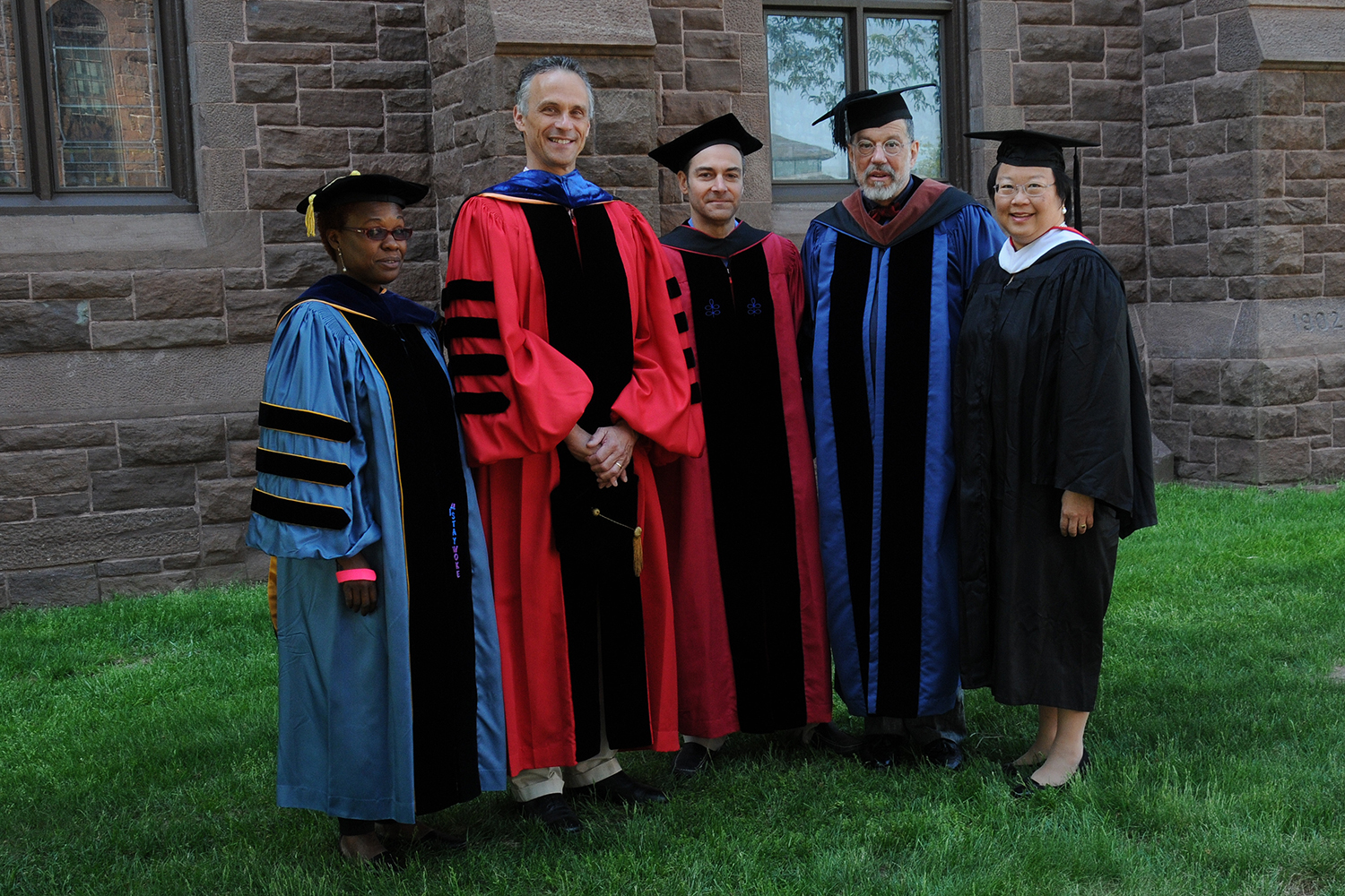 Wesleyan President Michael Roth (second of left) and Daphne Kwok '84, chair of the Wesleyan Alumni Association 9fifth from left) presented The Binswanger Prize for Excellence in Teaching to Gina Athena Ulysse (at left), Michael Calter and David Schorr. (Photo by John Van Vlack)