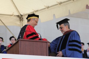 Wesleyan President Michael Roth congratulates David Schorr, at right. 