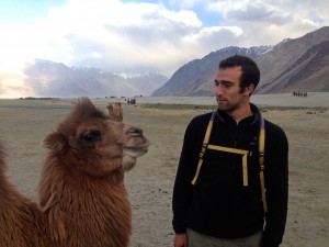 Greenwald with a camel in front of the Zangskar mountain range.