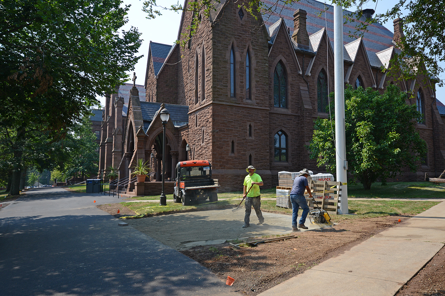 Crews lay stone for a patio between Memorial Chapel and South College on Aug. 19. 