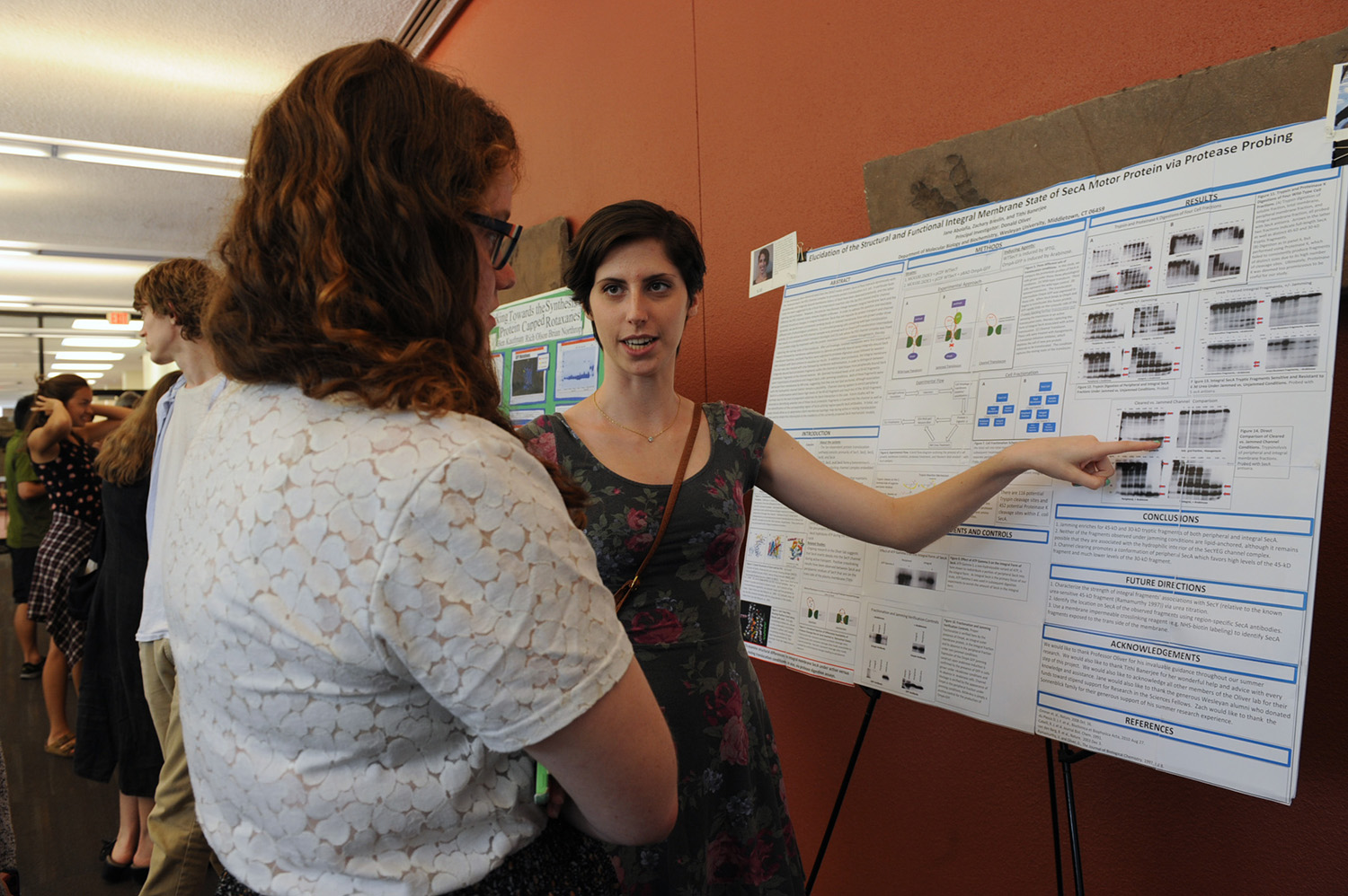 Jane Abolafia ’16 discusses her poster, "Elucidation of the Structural and Functional Integral Membrane State of SecA  Motor Protein via Protease Probing." Zachary Breslin ’16 also assisted with the research. Their adviser is  Donald Oliver, Daniel Ayres professor of biology, professor of molecular biology and biochemistry.