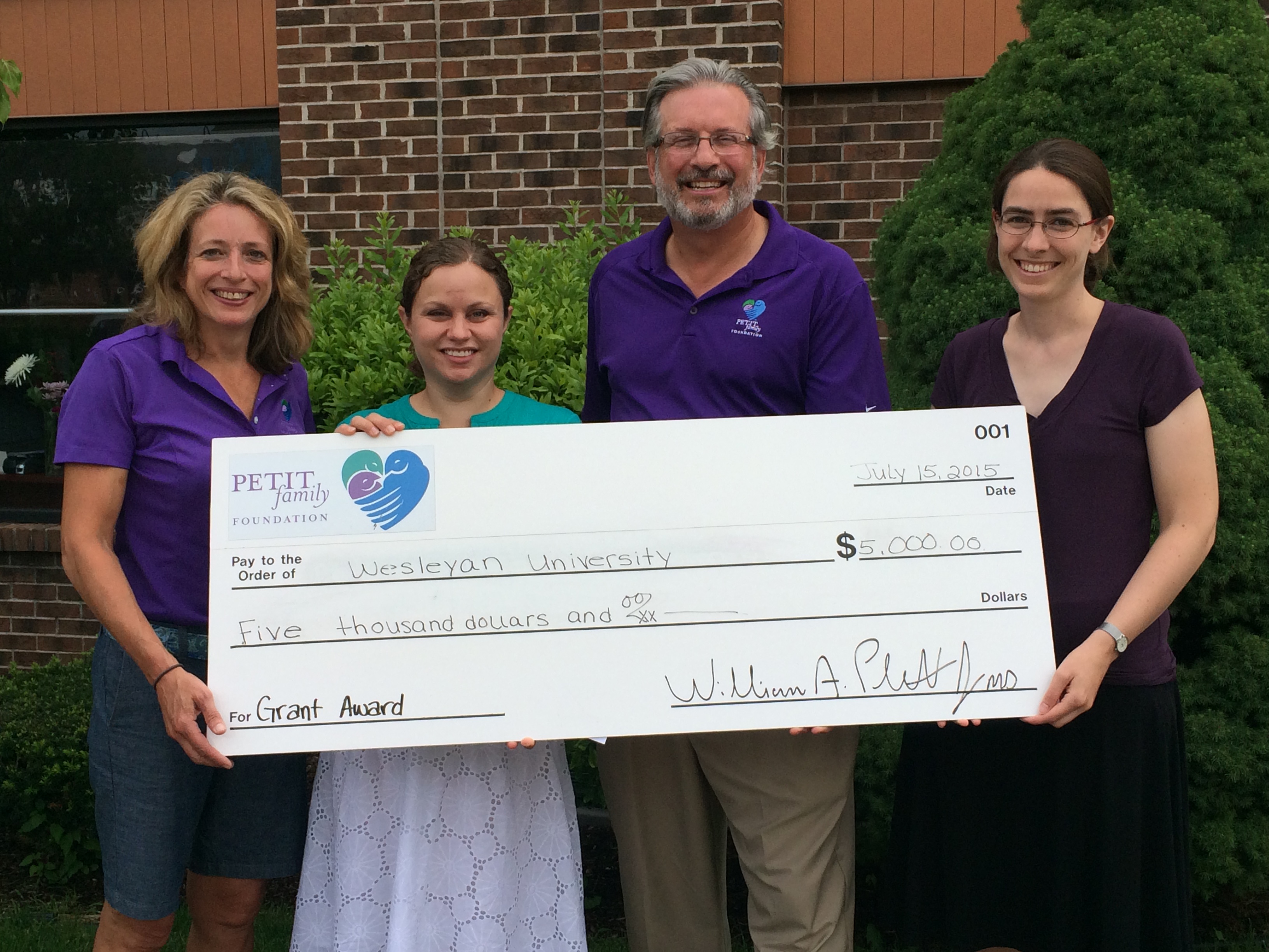 On July 15, the Petit Family Foundation awarded Wesleyan’s Physics Department with a $5,000 grant to support the 2016 Northeast Conference for Undergraduate Women in Physics (CUWiP). Pictured, from left is Kimberly Petit, Chris Othon, William Petit and Meredith Hughes. 
