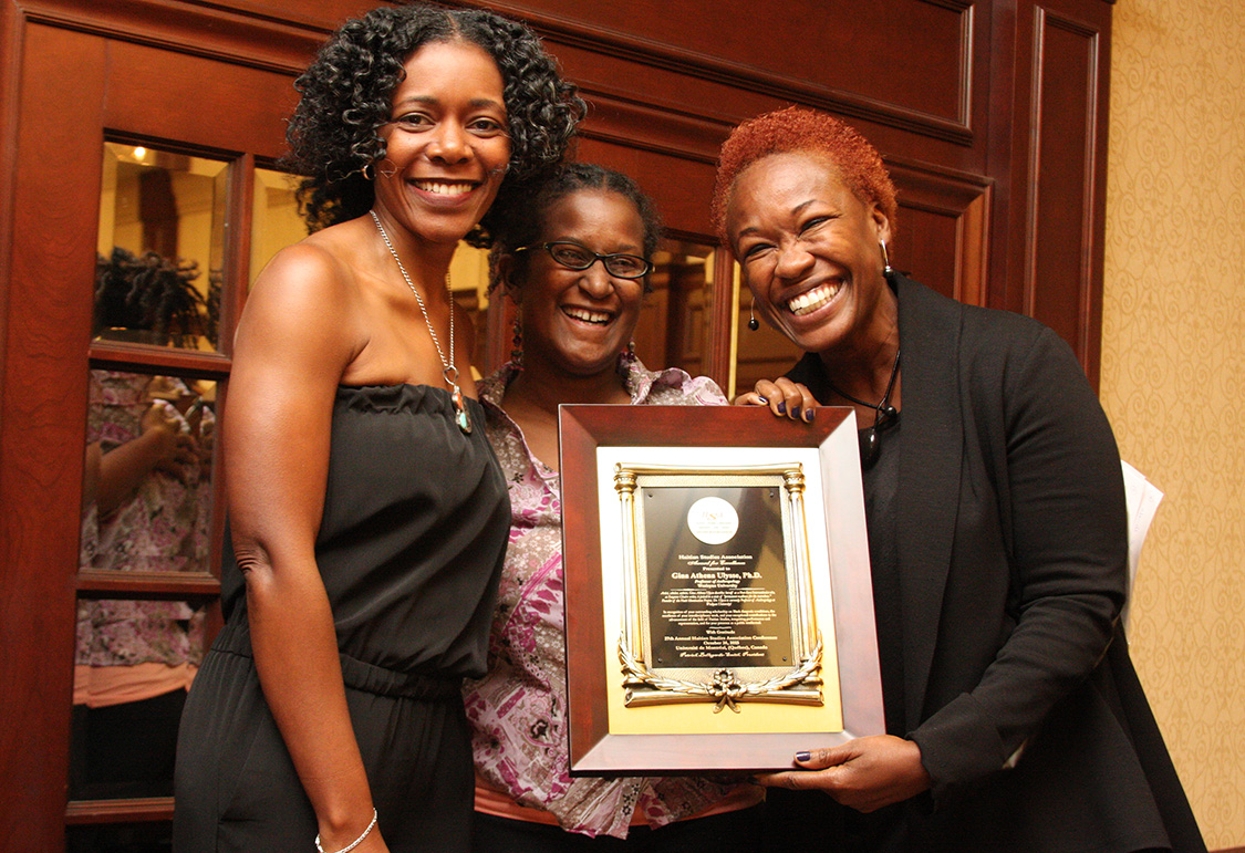 Pictured at right, Gina Ulysse received the Haitian Studies Association's Excellence in Scholarship award from association board members Régine Jackson and Nadève Menard. (Photo by Gregory Jean-Baptiste)
