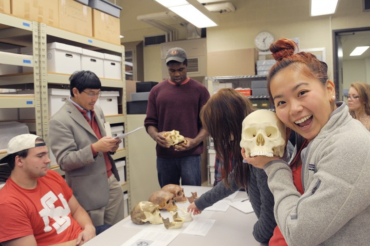 Anna Lu '17, who is enrolled in the HIST 368 class, History of Science and Technology in Modern China, holds a sample of Homo sapiens. Lu's class visited Wesleyan's Anthropology and Archaeology Collections on Nov. 11 to learn more about Chinese ancestry.