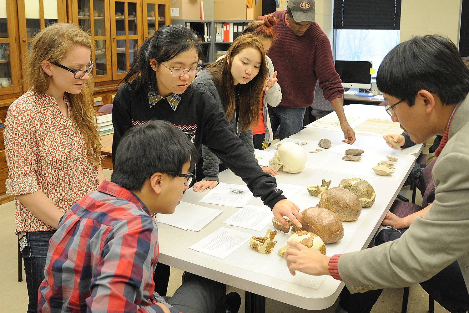 At right, Ying Jia Tan, assistant professor of history, taught his class, History of Science and Technology in Modern China, in Wesleyan's Anthropology and Archaeology Collections. 