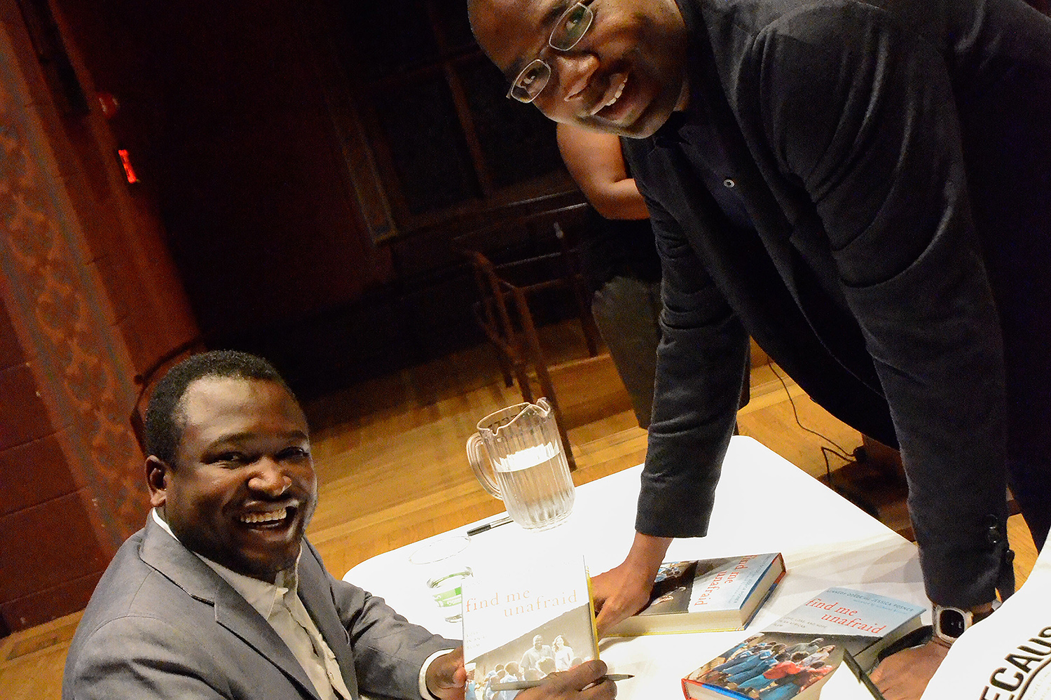 Kennedy Odede '12 (at left) and Jessica Posner Odede '09, co-founders of Shining Hope for Communities (SHOFCO) and co-authors of the new book "Find Me Unafraid: Love, Loss, and Hope in an African Slum," spoke at Memorial Chapel on Nov. 6 about their work in Kibera, Kenya. Kennedy also signed copies of their new book. (Photo by John Van Vlack)