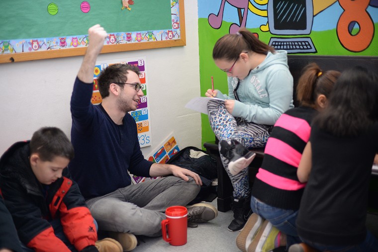 Jack Spira '16 speaks to 5th grader Meadow about her mythical creature "Powerball," who is the goddess of fire. 