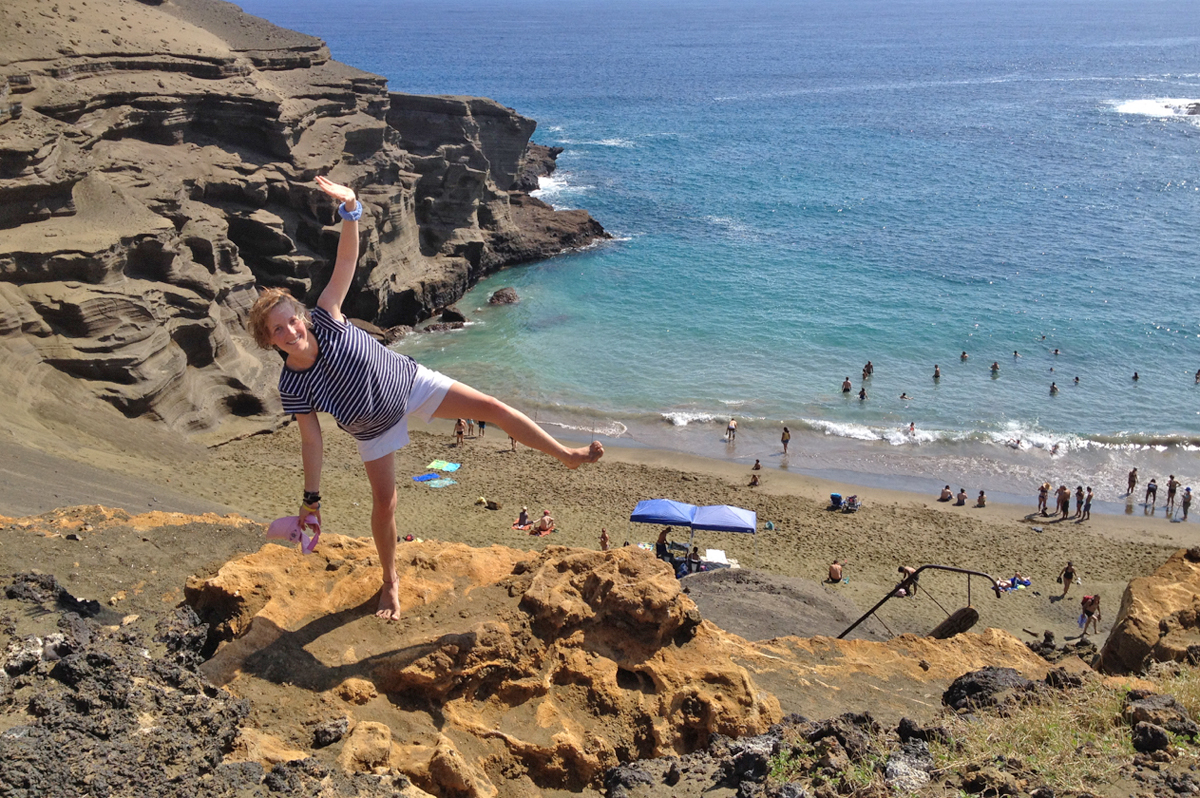Rebecca Hanschell '16 balances above the green sand beach Papakolea. The beach is unusual due to its high concentration of olivine sand.