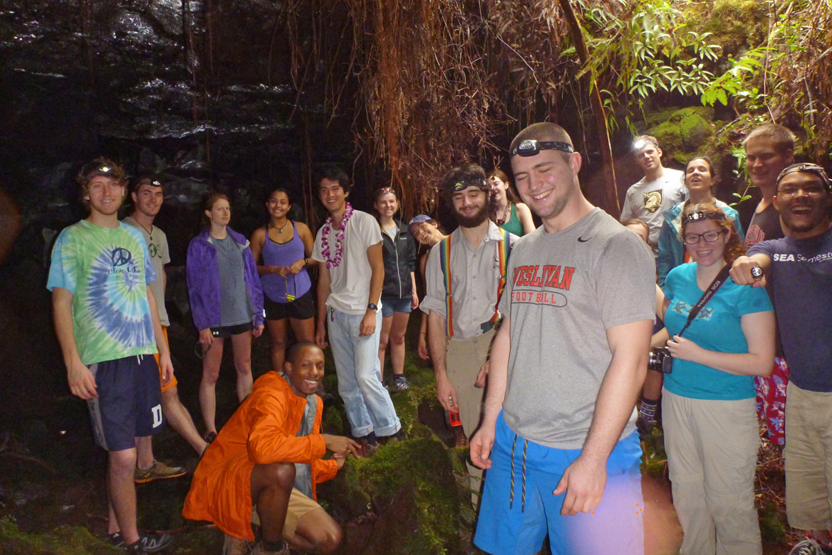 After a walk in near darkness, the class reaches an opening in the Kaumana Lava Tube.