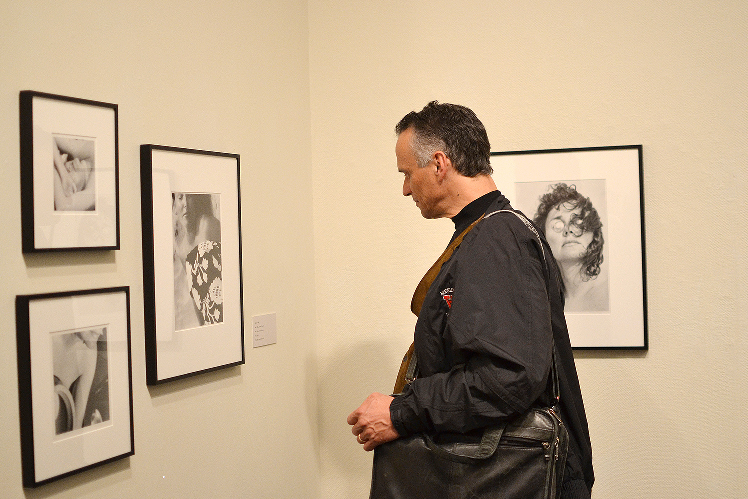 Wesleyan President Michael Roth examines Trager's black and white portraits. 