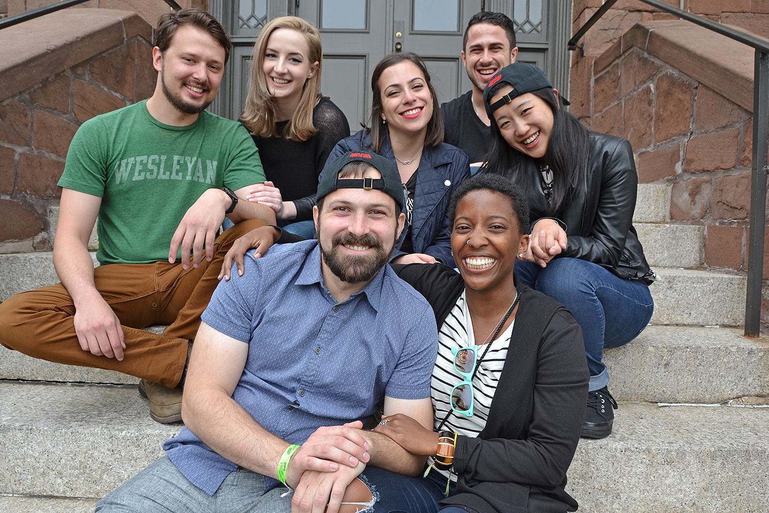 Friends and couples sit on the stairs of South College