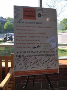 The poster with the pledge to be an agent of change is filled with signatures.