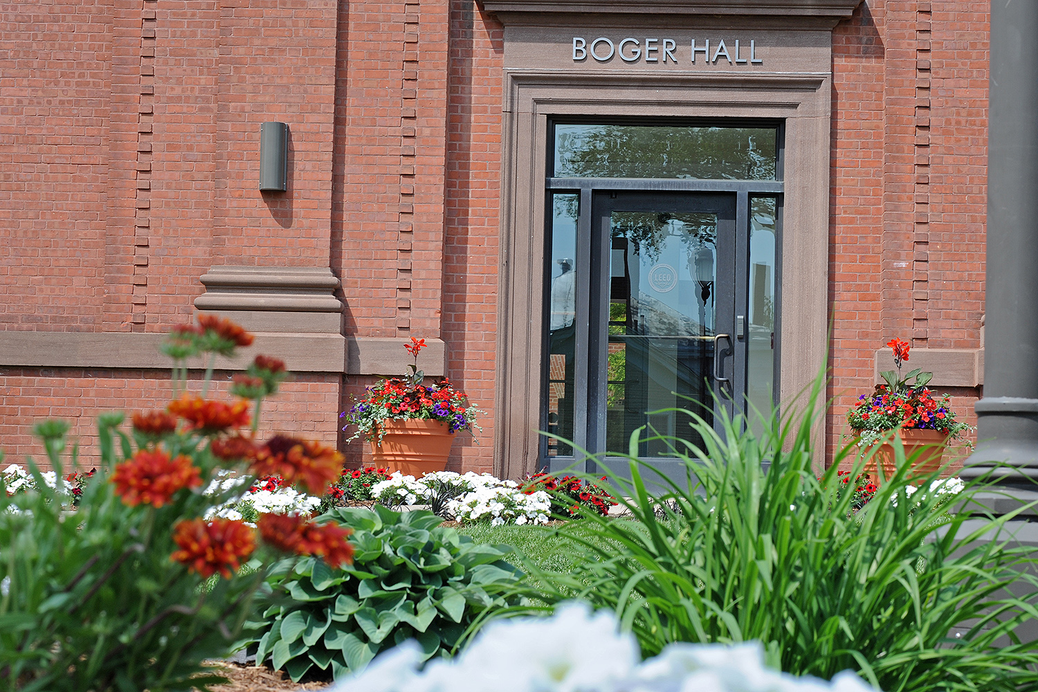 Petunias, geraniums and other flowers are planted near Boger Hall. 