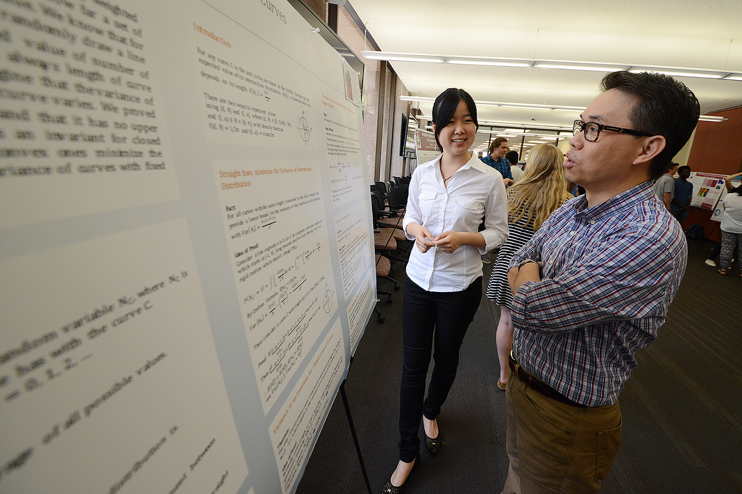 Fanying Chen ’18 speaks to Billy Chan, professor of mathematics about her study titled “Geometry and Intersection Distribution for Curves.” Chen’s advisor is David Constantine, assistant professor of mathematics. 