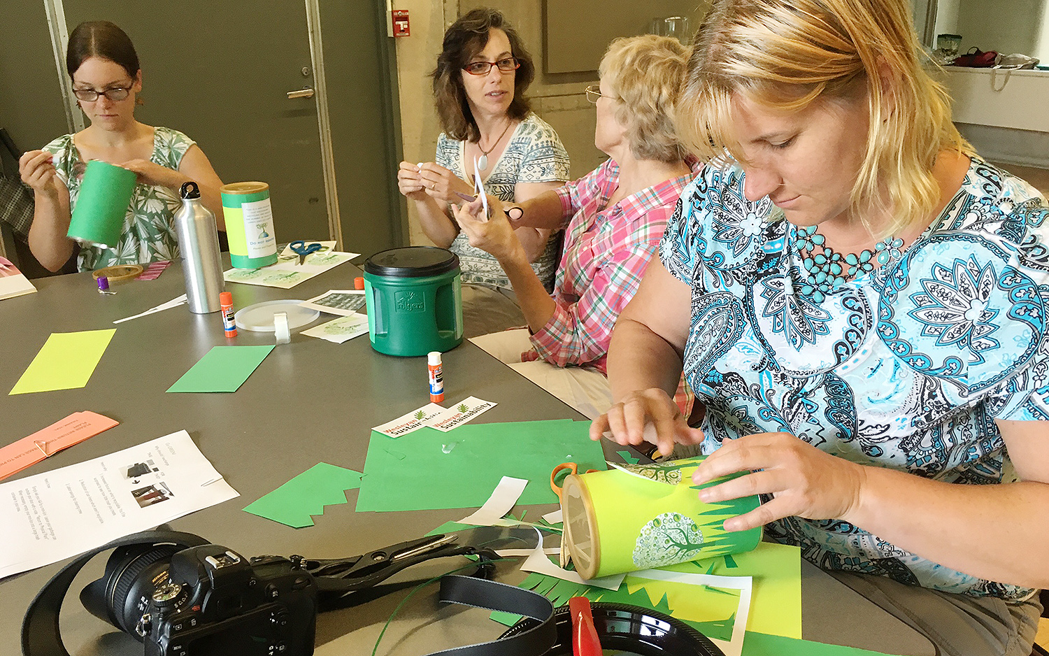 Olivia Drake, editor of The Wesleyan Connection and campus photographer, pastes recycle emblems to her mini-min. 