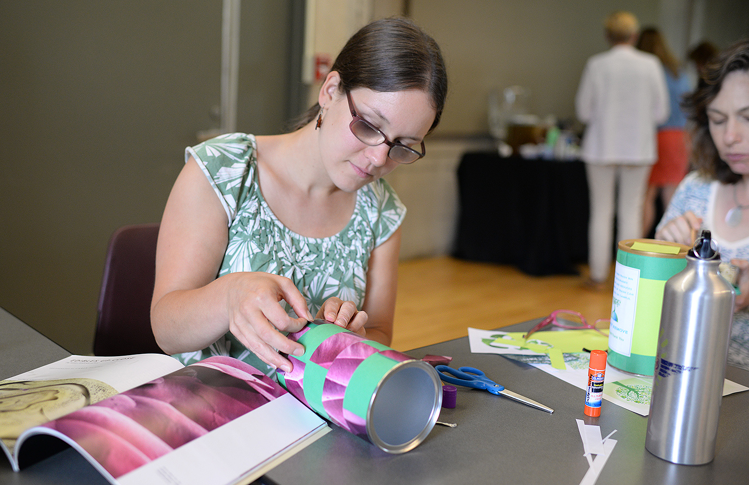 Jen Kleindienst, sustainability director, decorates her mini-bin with magazine images. 