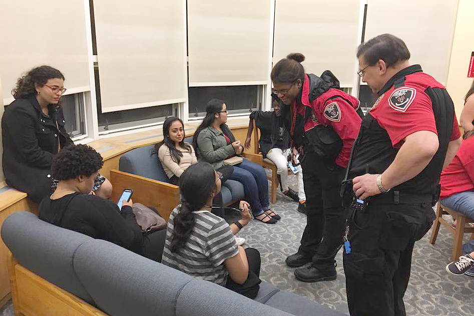 Officers Maggie Taylor and Ray Czaja mingle with students. 