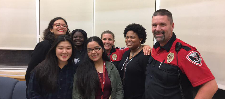 At right, Public Safety Supervisor Lt. Fred West and Officer Kathy Burdick, center, gather with Wesleyan students in Bennet Hall during "Pancakes with P-Safe."