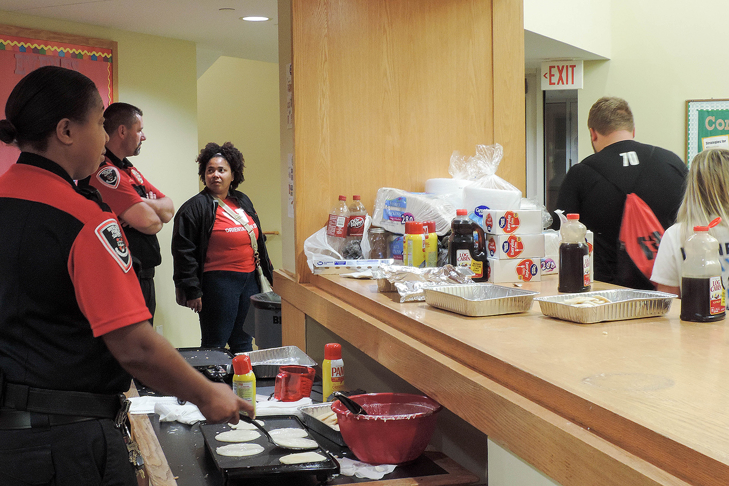 Second-shift Public Safety Officers cook pancakes in Bennet Hall. 