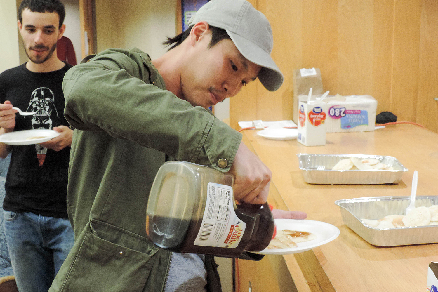 Calvin Au '19 tops his pancakes with syrup. 