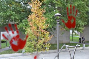 Stickers in the form of "bloody" handprints welcomed campus guests to Mysterium, the conference for mystery writers and readers. 