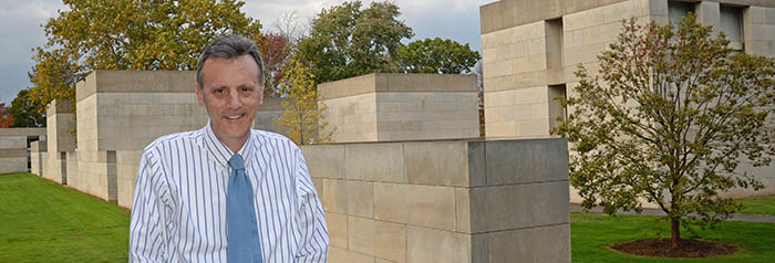 Professor Joe Siry stands outside in the Center for the Arts Complex on Oct. 17. 