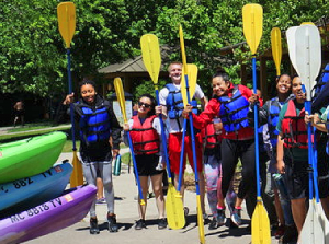 Kelly Lam, pictured second from left, joins fellow Doris Duke Conservation Scholars for a paddle in Michigan. 