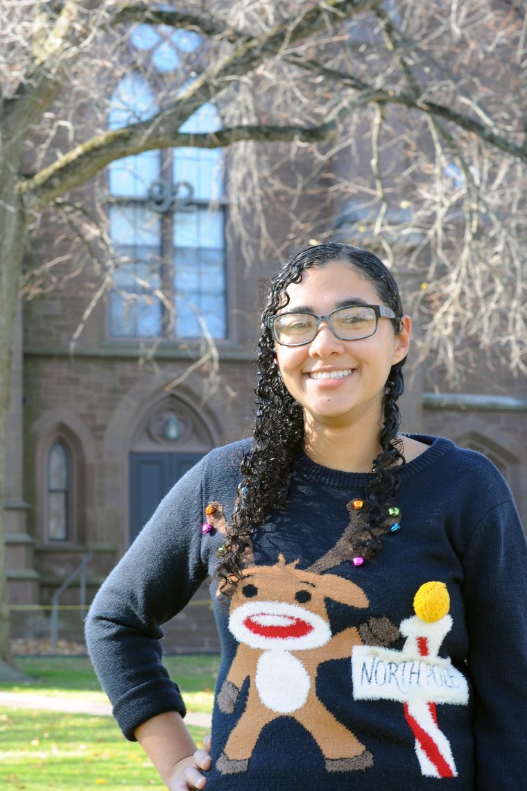 May Treuhaft-Ali '17, donning a reindeer sweater she acquired from a study abroad experience in Ireland, poses near the '92 Theater where she "spends half her time." Treuhaft-Ali recently was awarded a Mitchell Scholarship to study theater and performance in Dublin. 